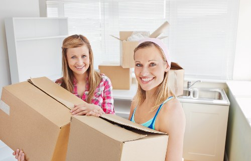 Packed moving boxes and furniture prepared for a local house move