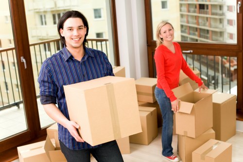 Removal crew handling furniture in a Friern Barnet flat move